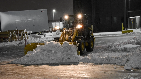 Metal Pless plowmaxx live edge plowing snow on a compact wheel loader