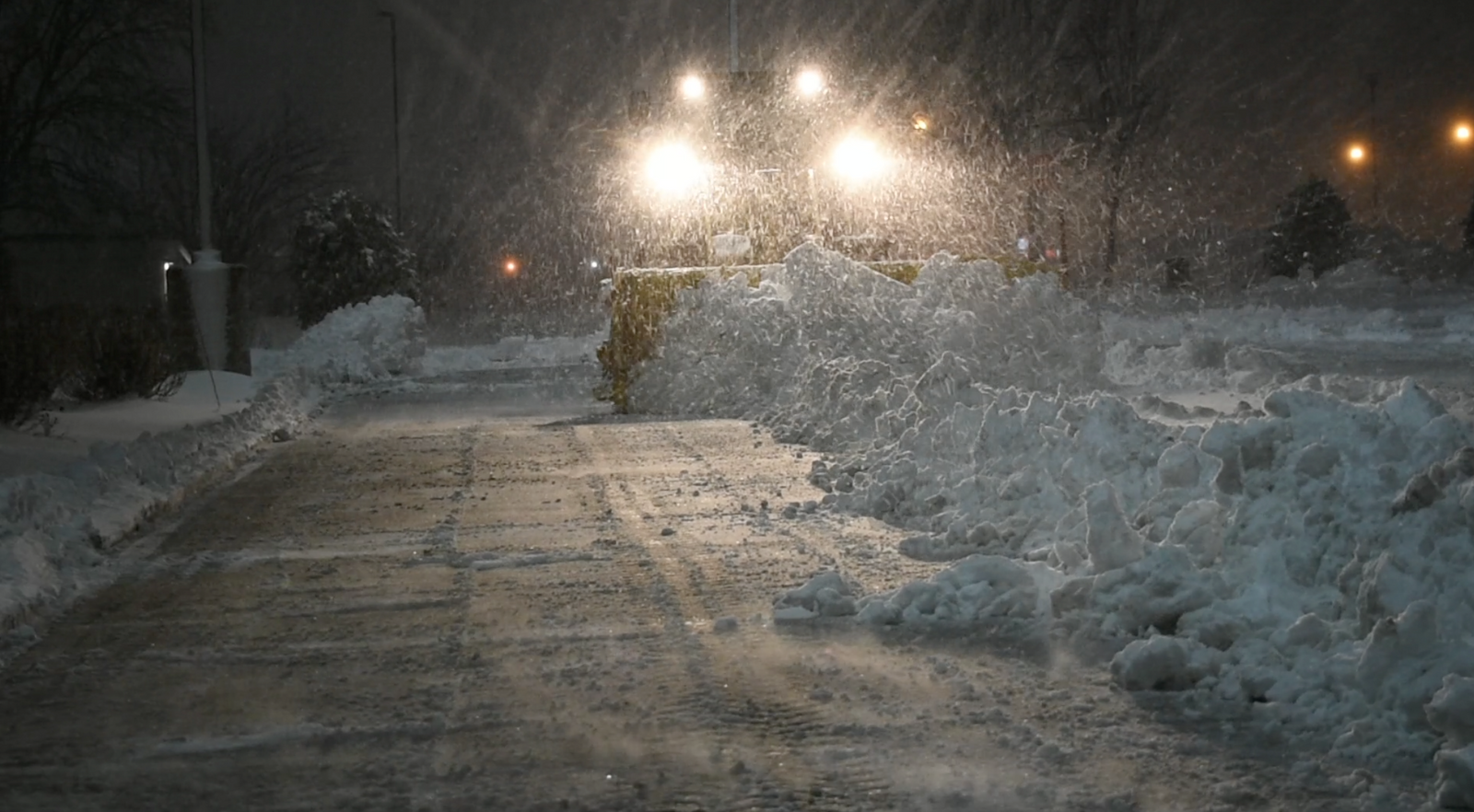 Metal Pless snow plow plowing snow at night
