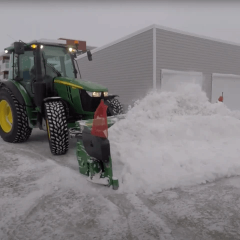 metal pless agrimaxx on a john deere pushing snow